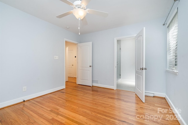 5424 Doncaster Dr, Charlotte, NC 28211 - unfurnished bedroom with light wood finished floors, baseboard heating, and ceiling fan