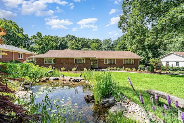 5424 Doncaster Dr, Charlotte, NC 28211 - ranch-style house with a front yard, brick siding, and a garden pond