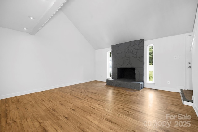 10101 Wood Ct, Charlotte, NC 28277 - unfurnished living room featuring vaulted ceiling, wood finished floors, and a fireplace