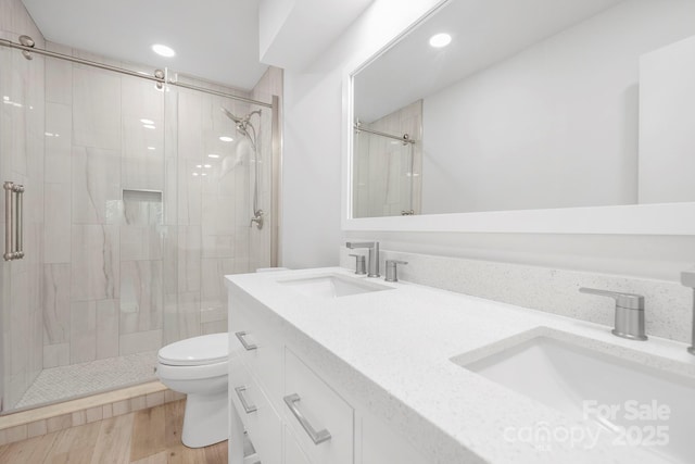 10101 Wood Ct, Charlotte, NC 28277 - full bathroom with a shower stall, recessed lighting, double vanity, and wood finished floors