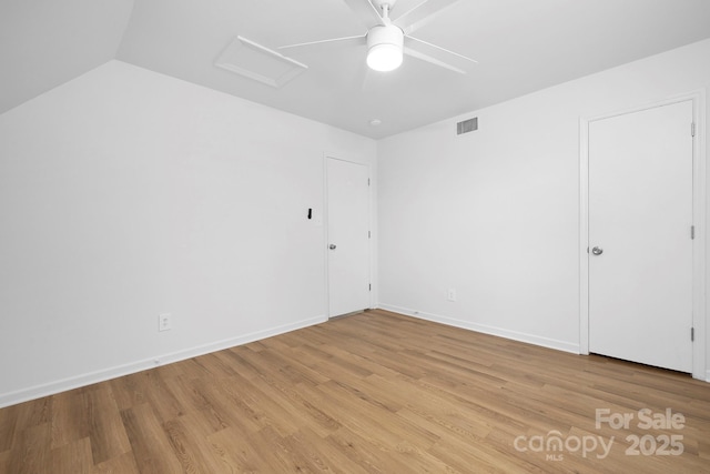10101 Wood Ct, Charlotte, NC 28277 - unfurnished bedroom with attic access, light wood finished floors, ceiling fan, and vaulted ceiling