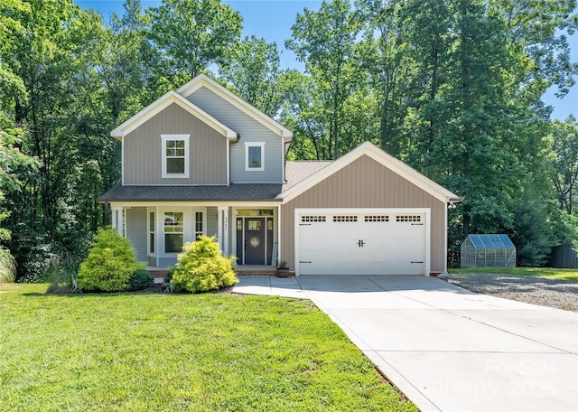3902 Mcgee Point Rd, Terrell, NC 28682 - view of front of property with concrete driveway, an attached garage, a front lawn, a shingled roof, and an exterior structure