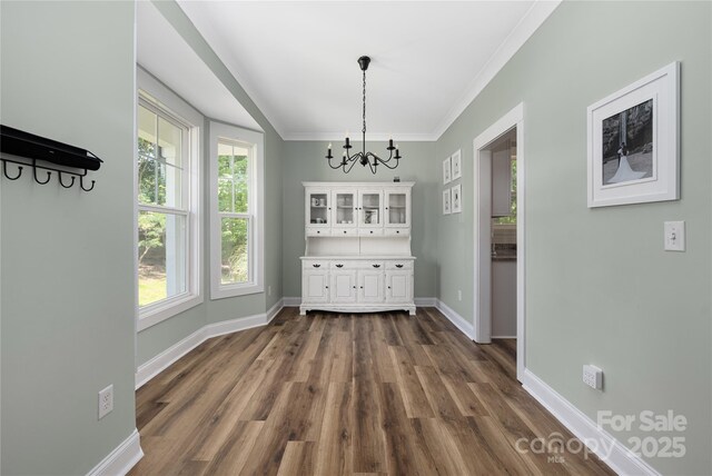 3902 Mcgee Point Rd, Terrell, NC 28682 - unfurnished dining area with a chandelier, dark wood-style flooring, baseboards, and ornamental molding