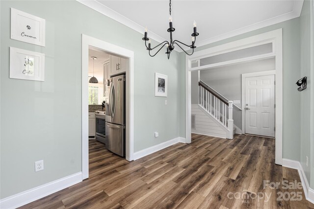 3902 Mcgee Point Rd, Terrell, NC 28682 - unfurnished dining area featuring a chandelier, dark wood-style floors, baseboards, stairs, and crown molding
