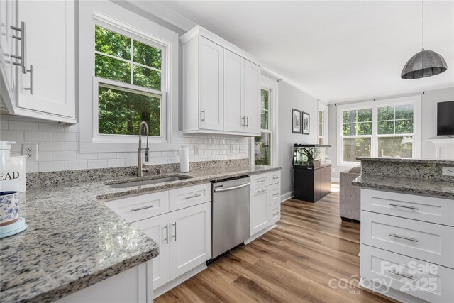 3902 Mcgee Point Rd, Terrell, NC 28682 - kitchen featuring dishwasher, a sink, tasteful backsplash, light wood-style floors, and white cabinetry
