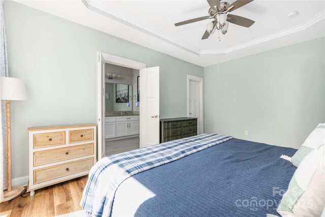 3902 Mcgee Point Rd, Terrell, NC 28682 - bedroom featuring a raised ceiling, wood finished floors, crown molding, ensuite bath, and ceiling fan
