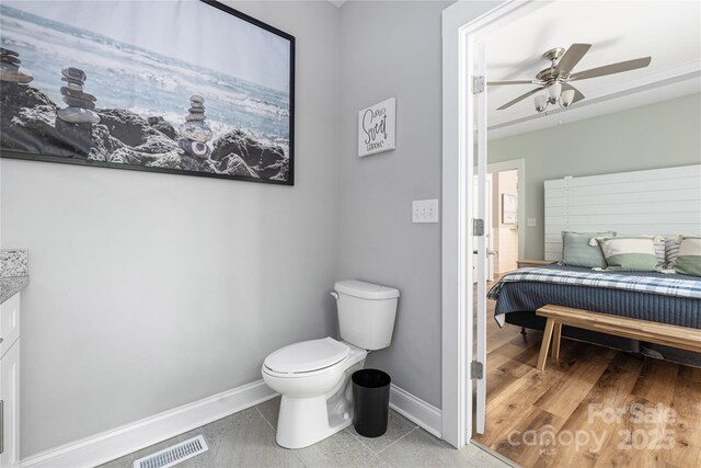 3902 Mcgee Point Rd, Terrell, NC 28682 - bathroom with baseboards, toilet, and a ceiling fan
