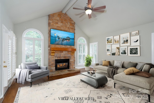 4672 Snow Dr, Harrisburg, NC 28075 - living room with a ceiling fan, wood finished floors, beam ceiling, a fireplace, and high vaulted ceiling