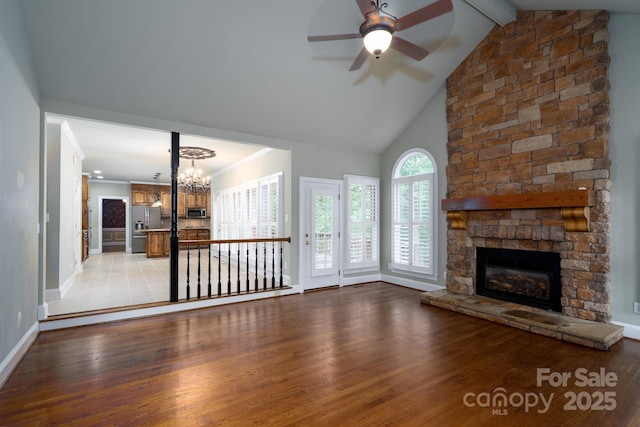 4672 Snow Dr, Harrisburg, NC 28075 - unfurnished living room with a fireplace, light wood-style flooring, ceiling fan, a chandelier, and beam ceiling
