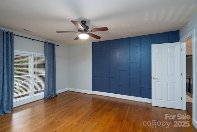 4672 Snow Dr, Harrisburg, NC 28075 - empty room with ceiling fan, baseboards, and wood finished floors