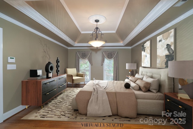4672 Snow Dr, Harrisburg, NC 28075 - bedroom featuring a tray ceiling, wood finished floors, ornamental molding, and baseboards