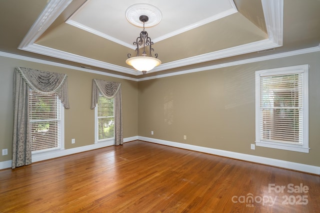 4672 Snow Dr, Harrisburg, NC 28075 - unfurnished room featuring a tray ceiling, ornamental molding, wood finished floors, and baseboards