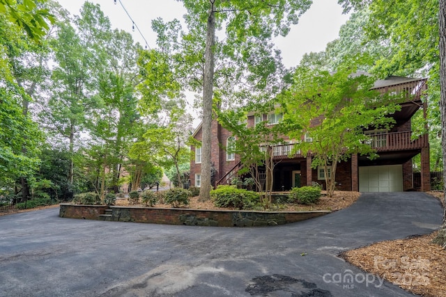 4672 Snow Dr, Harrisburg, NC 28075 - view of property hidden behind natural elements with a garage and driveway