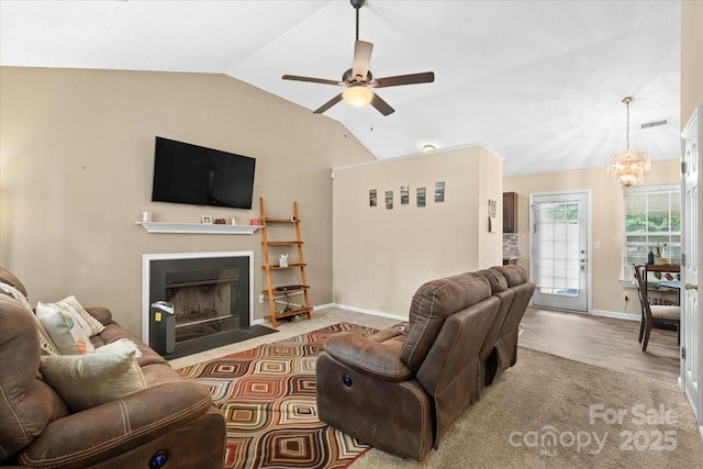 209 Mcfadden St, Rock Hill, SC 29730 - living area with a ceiling fan, vaulted ceiling, a fireplace with flush hearth, wood finished floors, and a chandelier