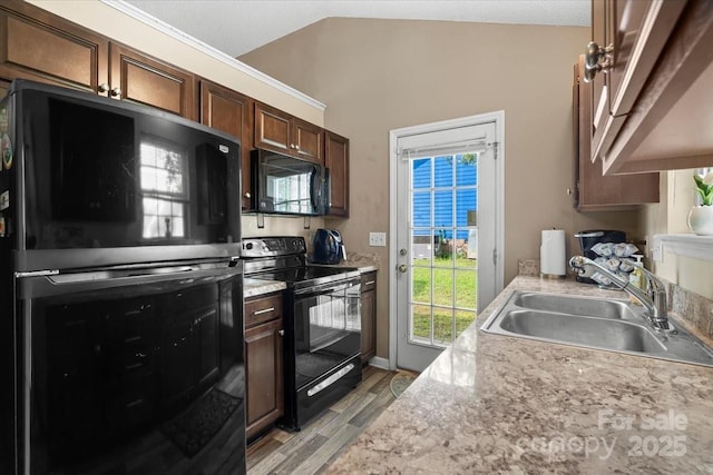 209 Mcfadden St, Rock Hill, SC 29730 - kitchen featuring black appliances, light wood-style floors, light countertops, and dark brown cabinets