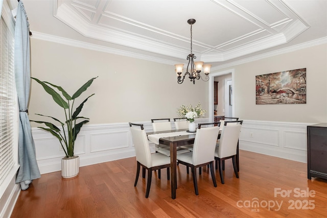 10106 Silverling Dr, Waxhaw, NC 28173 - dining area featuring a chandelier, light wood-style flooring, crown molding, wainscoting, and a decorative wall