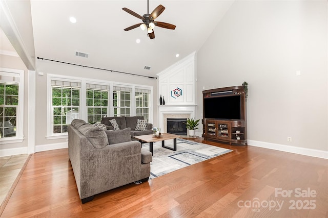 10106 Silverling Dr, Waxhaw, NC 28173 - living area with ceiling fan, high vaulted ceiling, light wood finished floors, a large fireplace, and recessed lighting