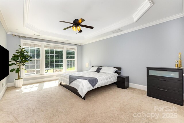 10106 Silverling Dr, Waxhaw, NC 28173 - carpeted bedroom featuring a tray ceiling, ornamental molding, and a ceiling fan