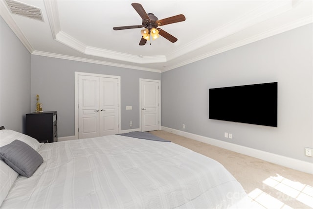 10106 Silverling Dr, Waxhaw, NC 28173 - bedroom with a raised ceiling, ornamental molding, light carpet, a ceiling fan, and a closet