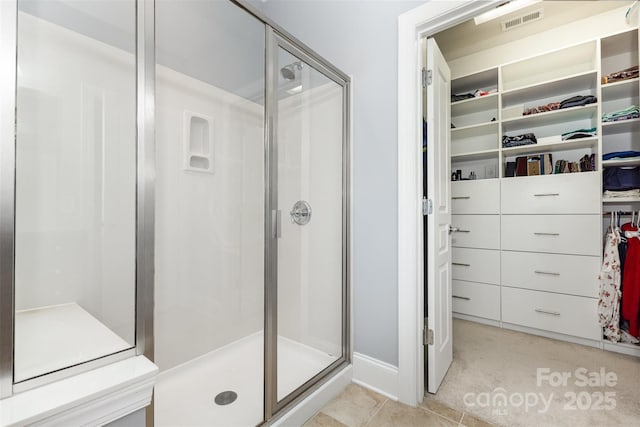 10106 Silverling Dr, Waxhaw, NC 28173 - bathroom with a shower stall, a spacious closet, and tile patterned flooring
