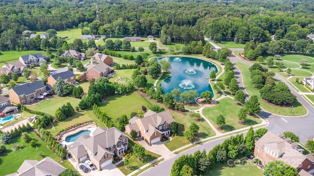 10106 Silverling Dr, Waxhaw, NC 28173 - aerial perspective of suburban area with a nearby body of water and a heavily wooded area