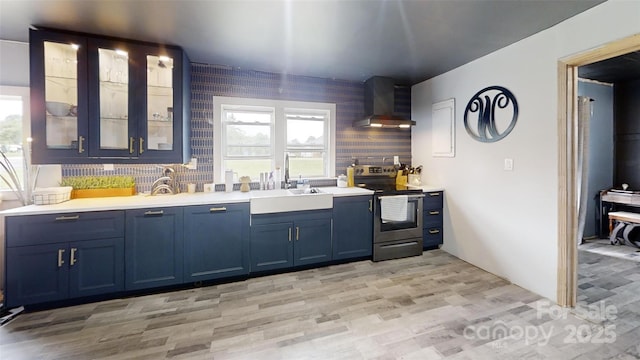 751 Northbrook Iii School Rd, Vale, NC 28168 - kitchen with wall chimney range hood, stainless steel range with electric stovetop, a sink, blue cabinetry, and light countertops