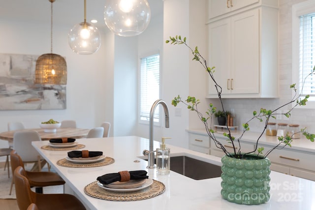 4203 Walker Rd, Charlotte, NC 28211 - kitchen featuring plenty of natural light, backsplash, light countertops, and decorative light fixtures