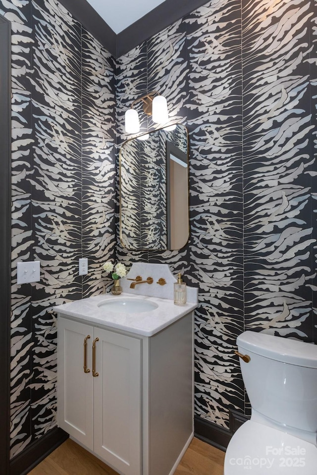4203 Walker Rd, Charlotte, NC 28211 - half bath with vanity, wood finished floors, and wallpapered walls