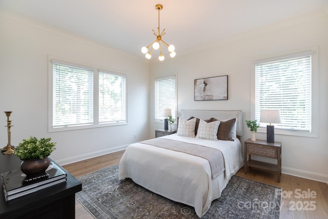 4203 Walker Rd, Charlotte, NC 28211 - bedroom with a chandelier, multiple windows, and light wood-type flooring