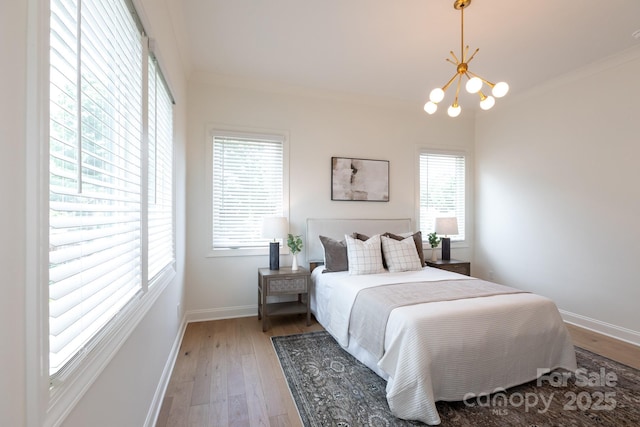 4203 Walker Rd, Charlotte, NC 28211 - bedroom featuring light wood-type flooring, a chandelier, and ornamental molding