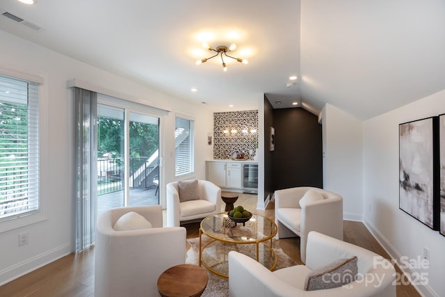 4203 Walker Rd, Charlotte, NC 28211 - living room with beverage cooler, light wood-type flooring, lofted ceiling, recessed lighting, and a chandelier