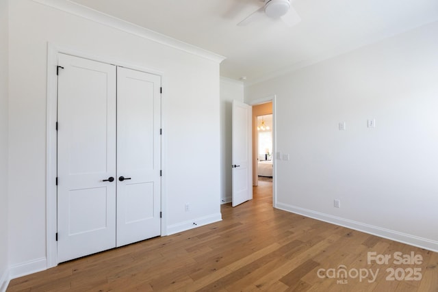 4203 Walker Rd, Charlotte, NC 28211 - unfurnished bedroom with ornamental molding, light wood-style flooring, a closet, and a ceiling fan