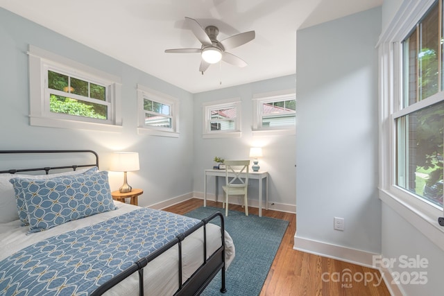 2421 Morton St, Charlotte, NC 28208 - bedroom featuring baseboards, wood finished floors, and ceiling fan
