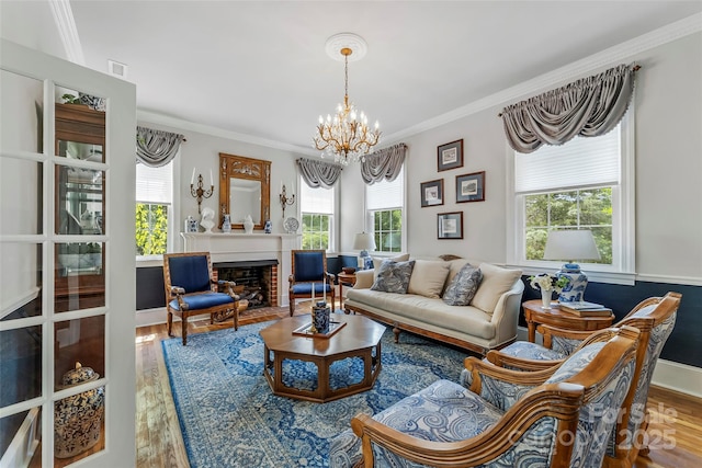 958 US-64, Morganton, NC 28655 - living room featuring wood finished floors, a chandelier, crown molding, and a fireplace with flush hearth