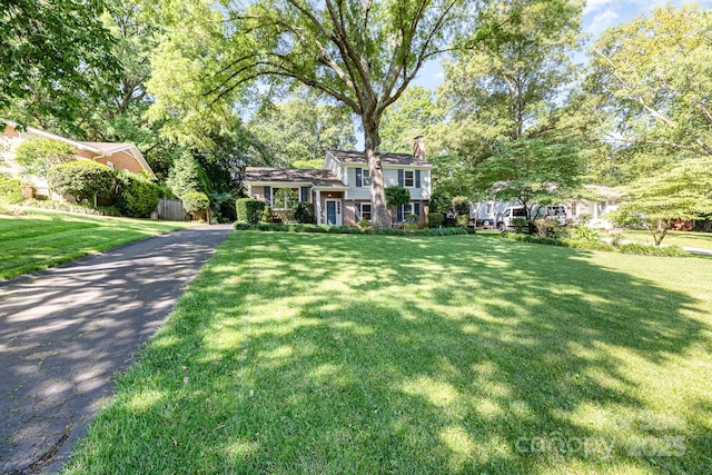 4200 Tyndale Ave, Charlotte, NC 28210 - tri-level home with a chimney, a front lawn, and asphalt driveway