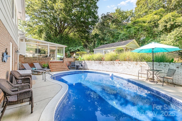 4200 Tyndale Ave, Charlotte, NC 28210 - view of pool with a sunroom, a patio, a fenced backyard, and view of wooded area