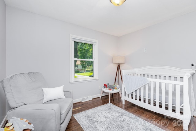 4200 Tyndale Ave, Charlotte, NC 28210 - bedroom with wood finished floors, baseboards, and a crib
