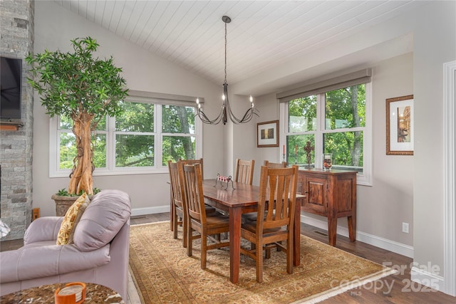 24 Herron View Ln, Weaverville, NC 28787 - dining room featuring lofted ceiling, plenty of natural light, a chandelier, a fireplace, and wood finished floors