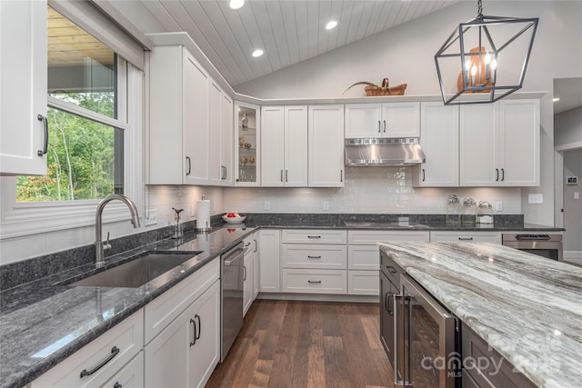 24 Herron View Ln, Weaverville, NC 28787 - kitchen with under cabinet range hood, recessed lighting, stainless steel dishwasher, vaulted ceiling, and dark wood finished floors