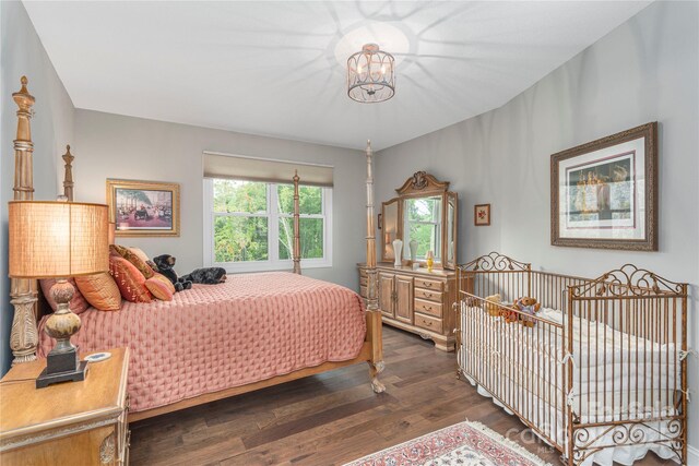24 Herron View Ln, Weaverville, NC 28787 - bedroom featuring wood finished floors and a chandelier