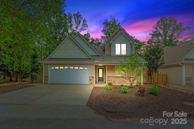 50 Beekeeper Trl, Swannanoa, NC 28778 - traditional home featuring an attached garage, concrete driveway, roof with shingles, and brick siding