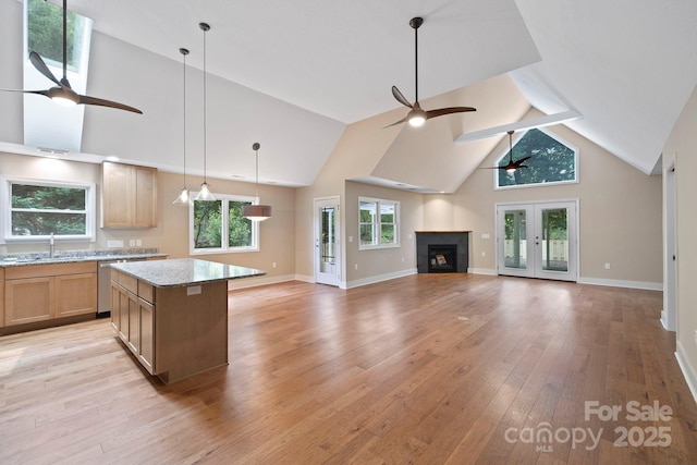 50 Beekeeper Trl, Swannanoa, NC 28778 - kitchen with ceiling fan, high vaulted ceiling, light wood finished floors, a kitchen island, and a fireplace