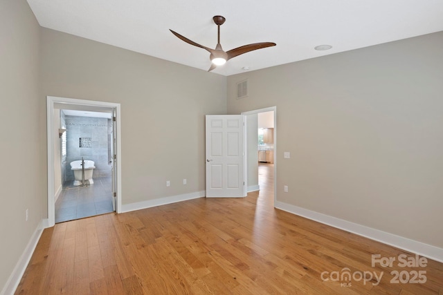 50 Beekeeper Trl, Swannanoa, NC 28778 - unfurnished bedroom featuring light wood-type flooring, baseboards, connected bathroom, and a ceiling fan