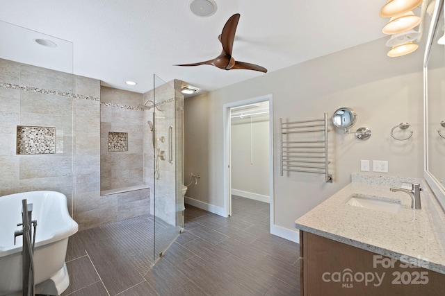 50 Beekeeper Trl, Swannanoa, NC 28778 - full bathroom featuring vanity, a walk in shower, ceiling fan, a towel warmer, and a freestanding tub