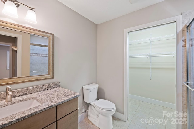 50 Beekeeper Trl, Swannanoa, NC 28778 - full bath with vanity, toilet, baseboards, tile patterned flooring, and a shower with shower door