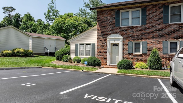 1330 5th St NE Unit 11, Hickory, NC 28601 - view of front of property with uncovered parking, brick siding, and an outbuilding