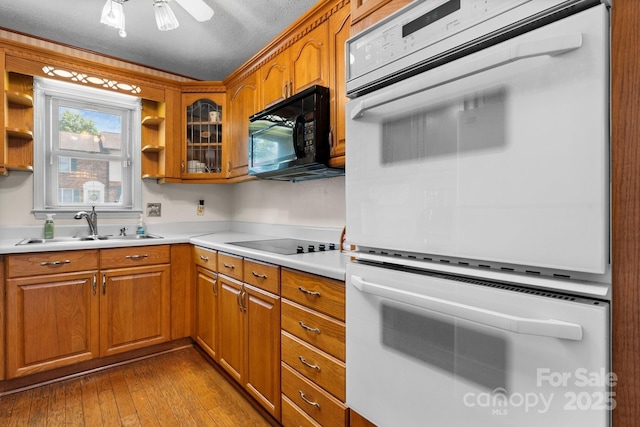 1330 5th St NE Unit 11, Hickory, NC 28601 - kitchen featuring black appliances, a sink, brown cabinetry, and open shelves