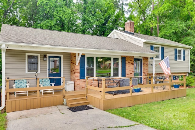 2111 Parkdale Ave, Gastonia, NC 28052 - tri-level home featuring brick siding, roof with shingles, a front yard, a porch, and a chimney