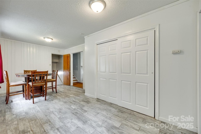 2111 Parkdale Ave, Gastonia, NC 28052 - dining room featuring a textured ceiling, ornamental molding, light wood finished floors, and stairway