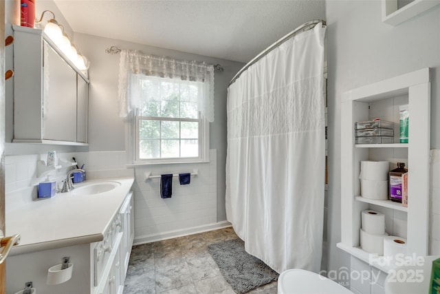 2111 Parkdale Ave, Gastonia, NC 28052 - bathroom featuring vanity, tile walls, toilet, curtained shower, and a textured ceiling